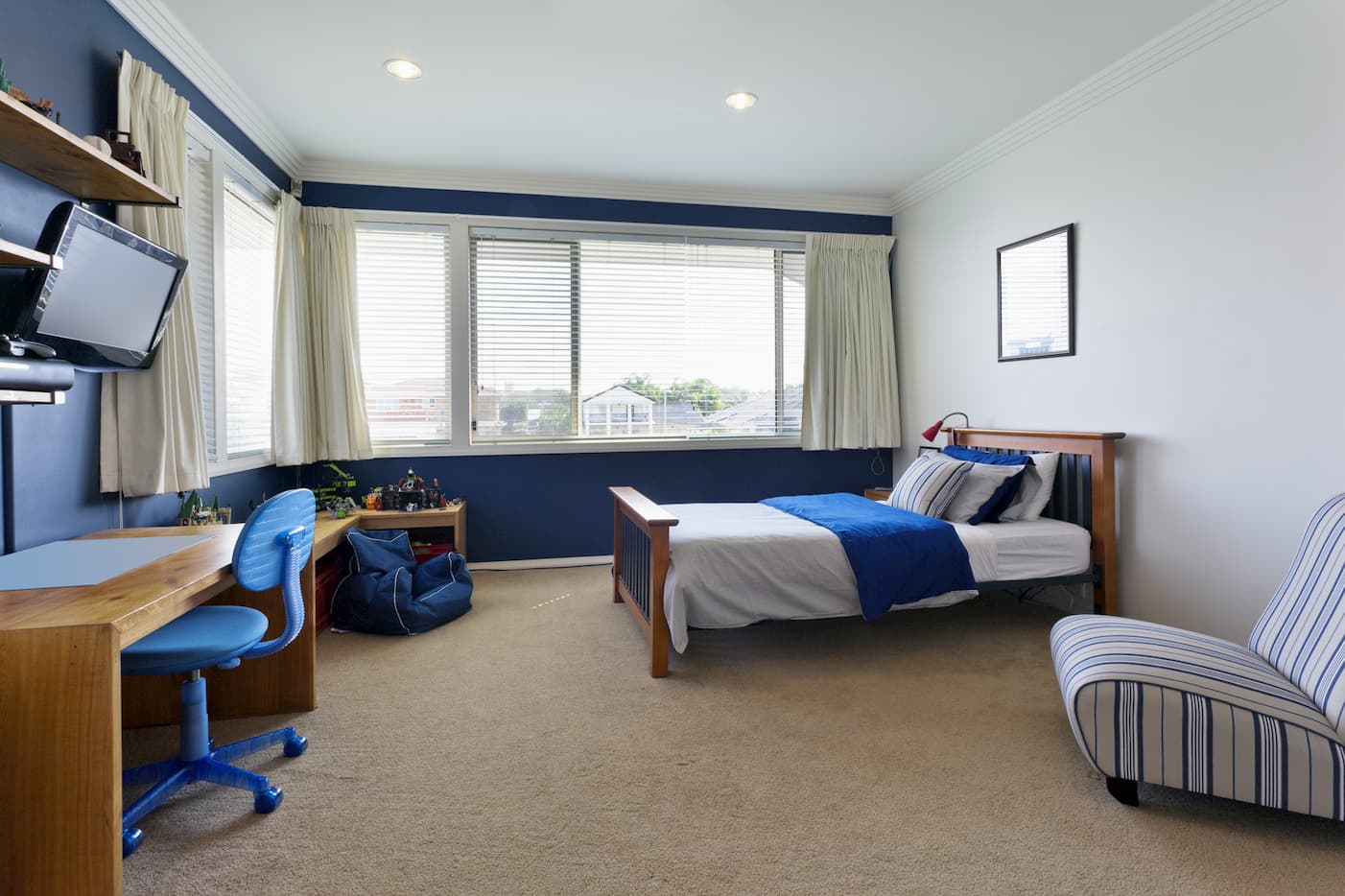 Stylish room with a bed, window, chair, and LCD